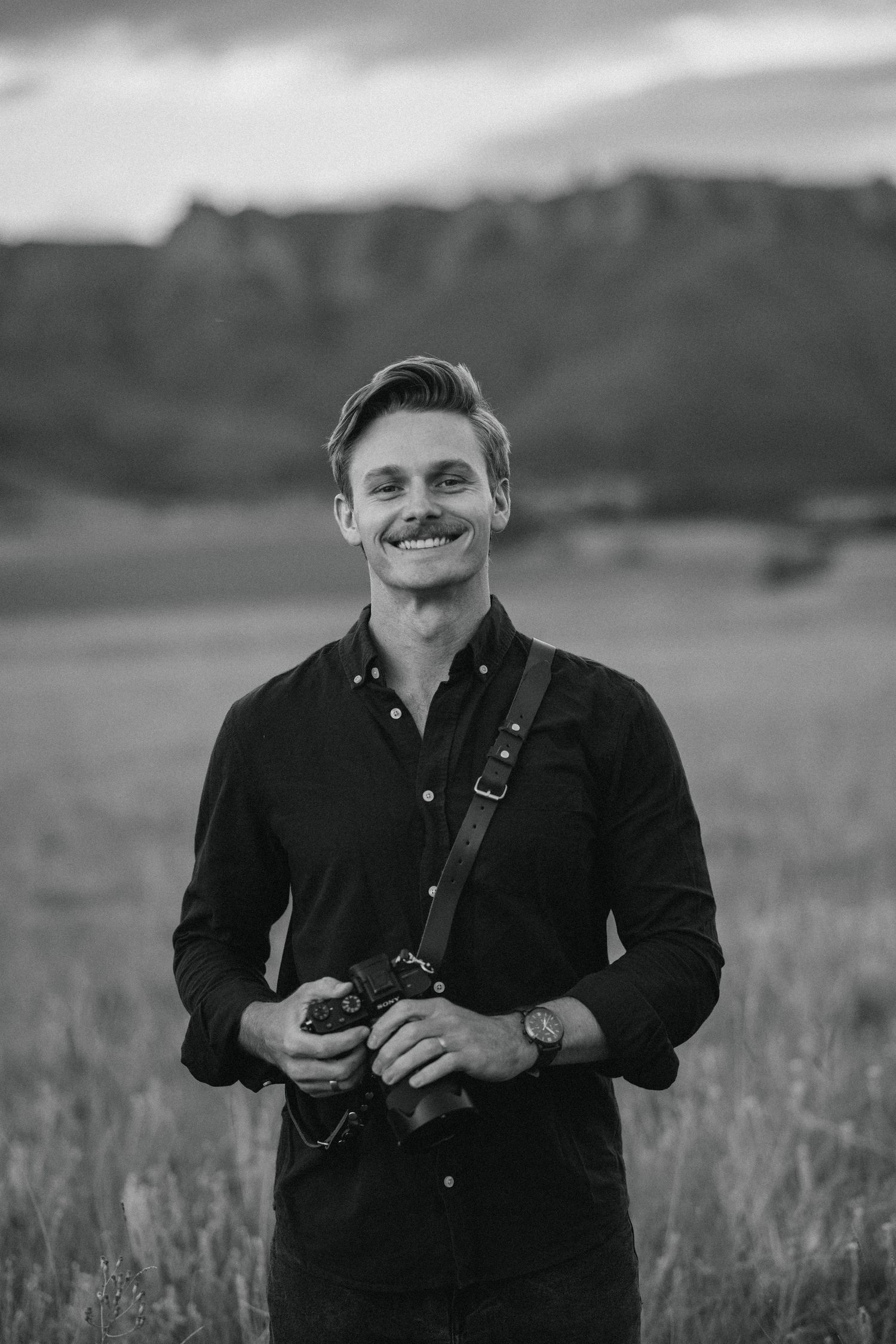 Jordie Captures shown with a camera in hand