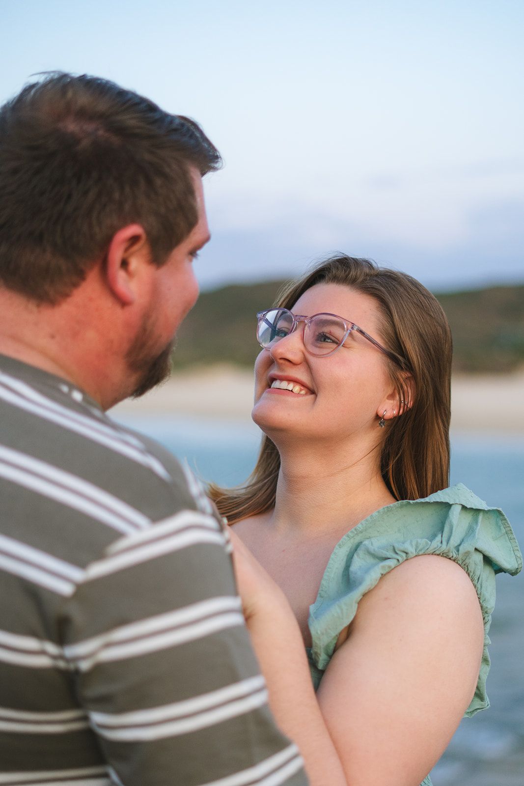 A couple on their engagement shoot at the beach photo taken by Jordie Captures