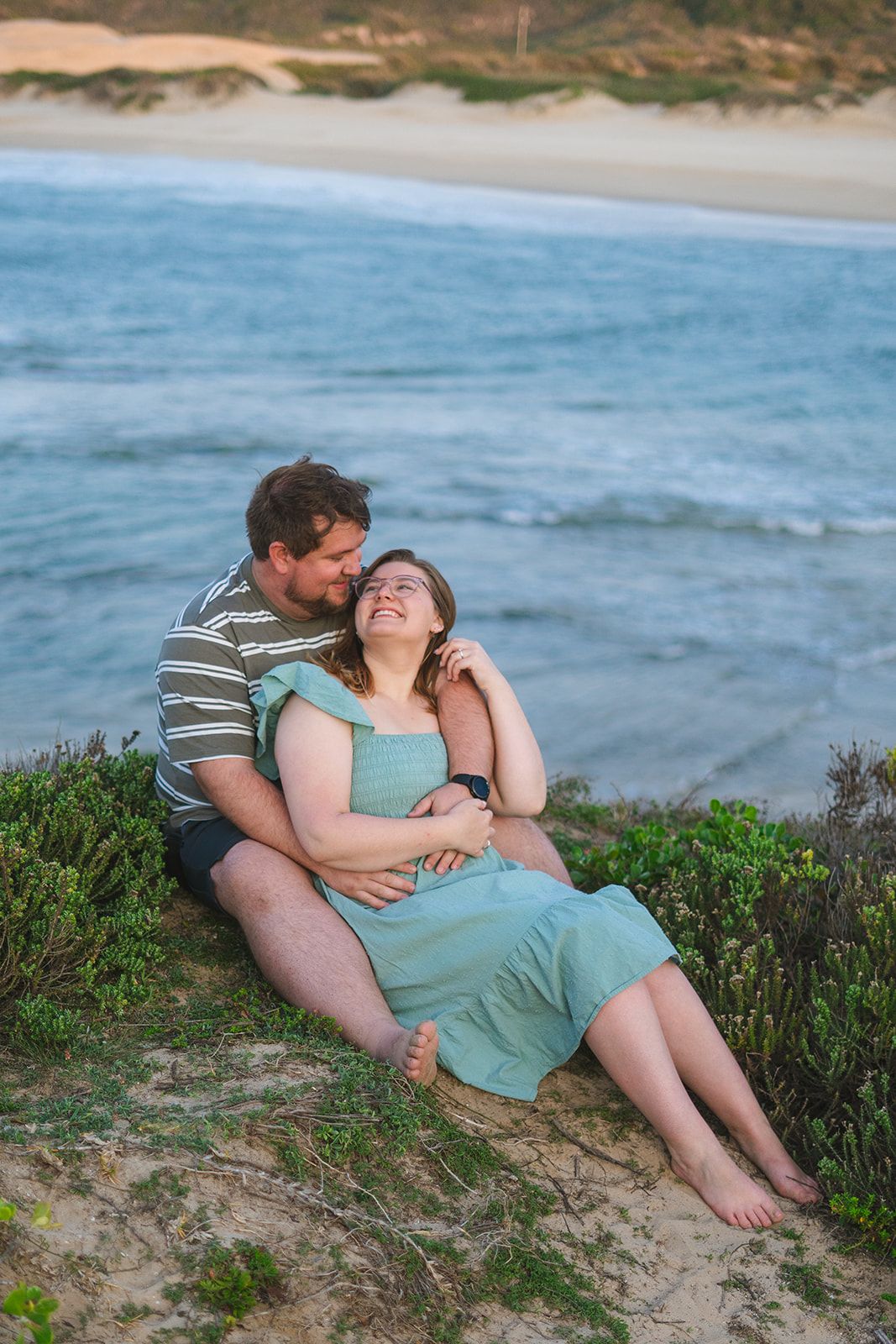 A couple on their engagement shoot at the beach photo taken by Jordie Captures