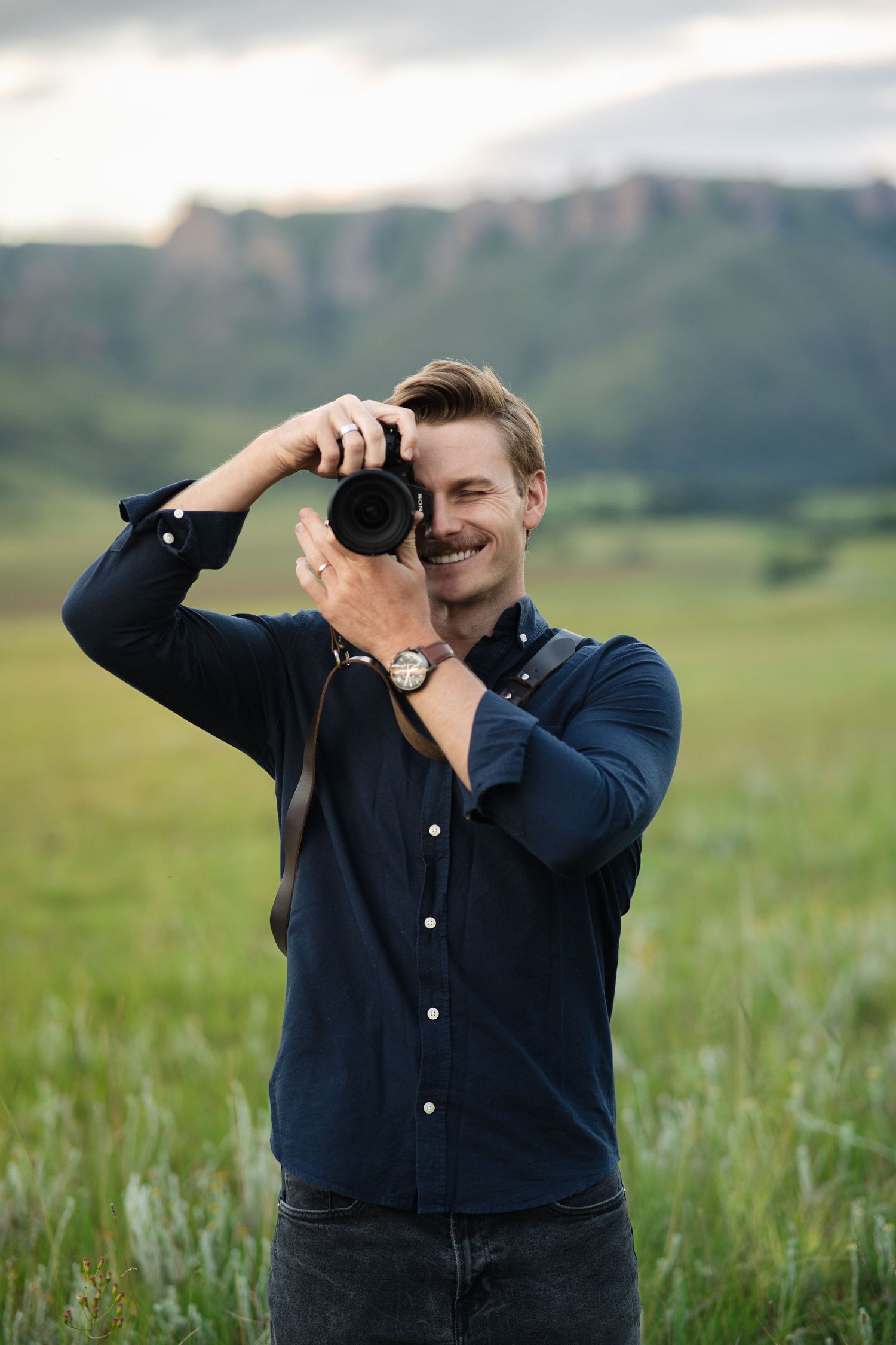 Jordie Captures shown with a camera in hand