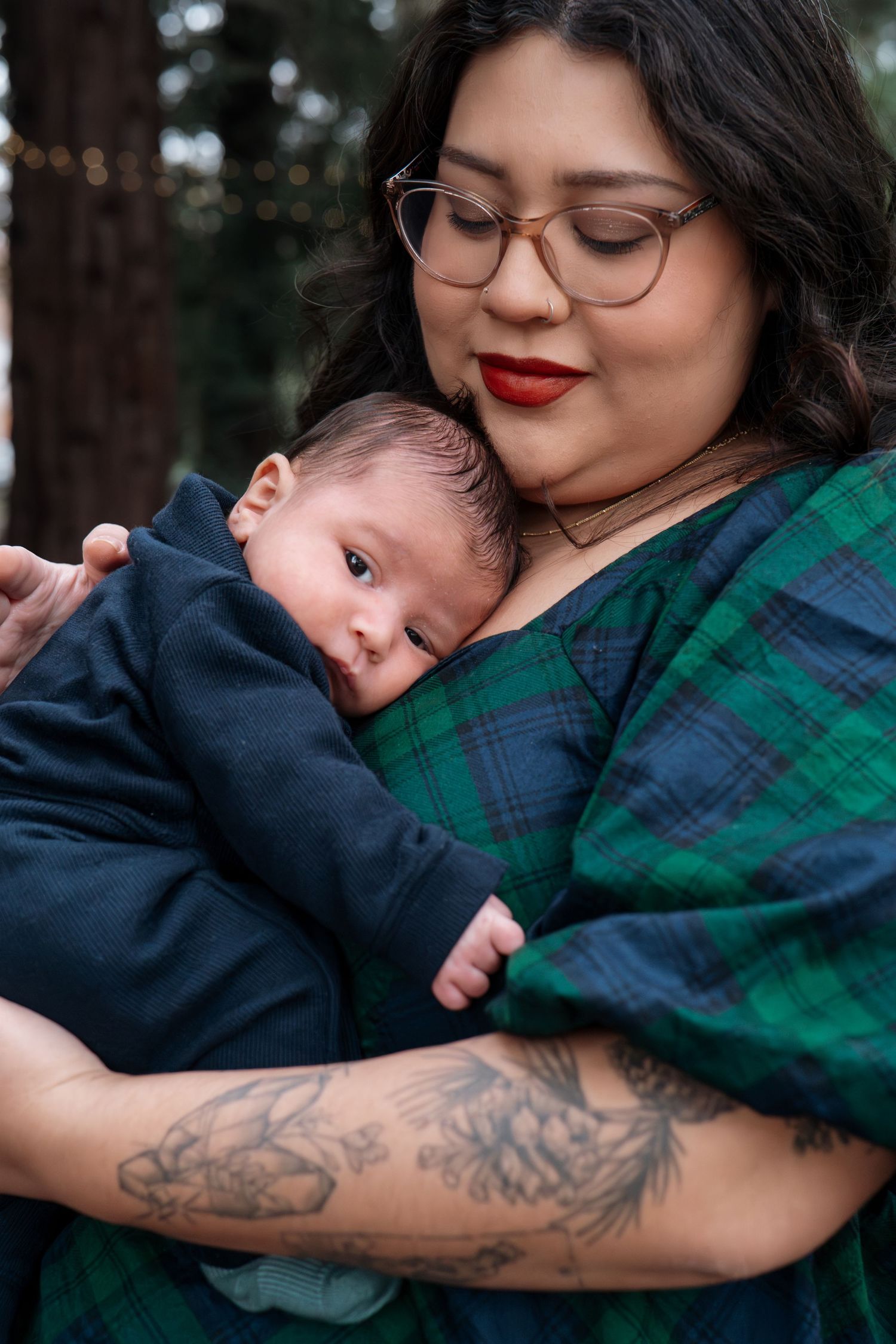 Intimate parental bonding moment captured in a series of gentle embraces under forest canopy in Roseville, CA