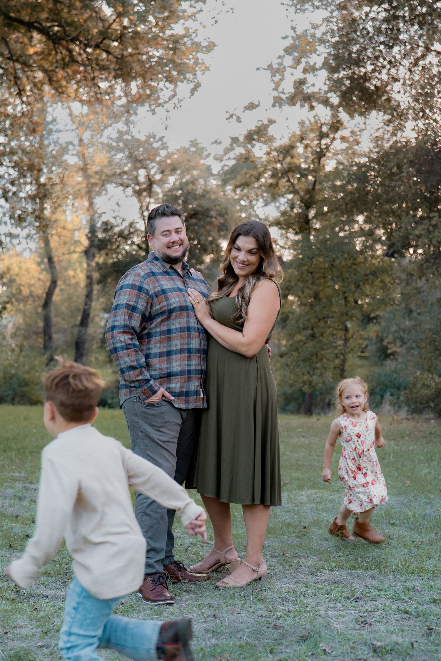 Family photoshoot in park with children running and playing in Roseville, CA