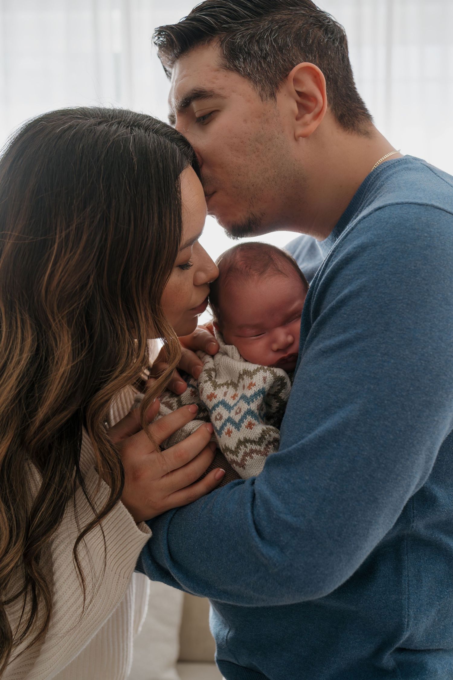 A tender family moment captured in a series of five intimate photos showing parents bonding with their newborn baby.