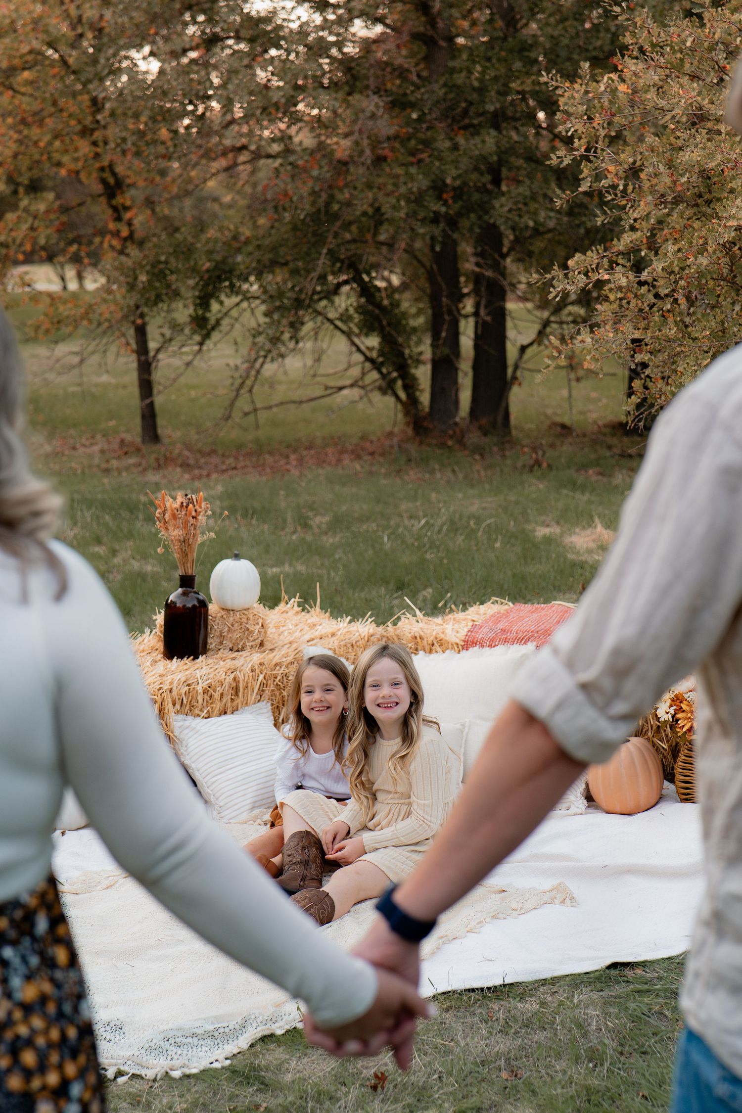 Family relaxing on white blanket during outdoor autumn photoshoot in Roseville, CA