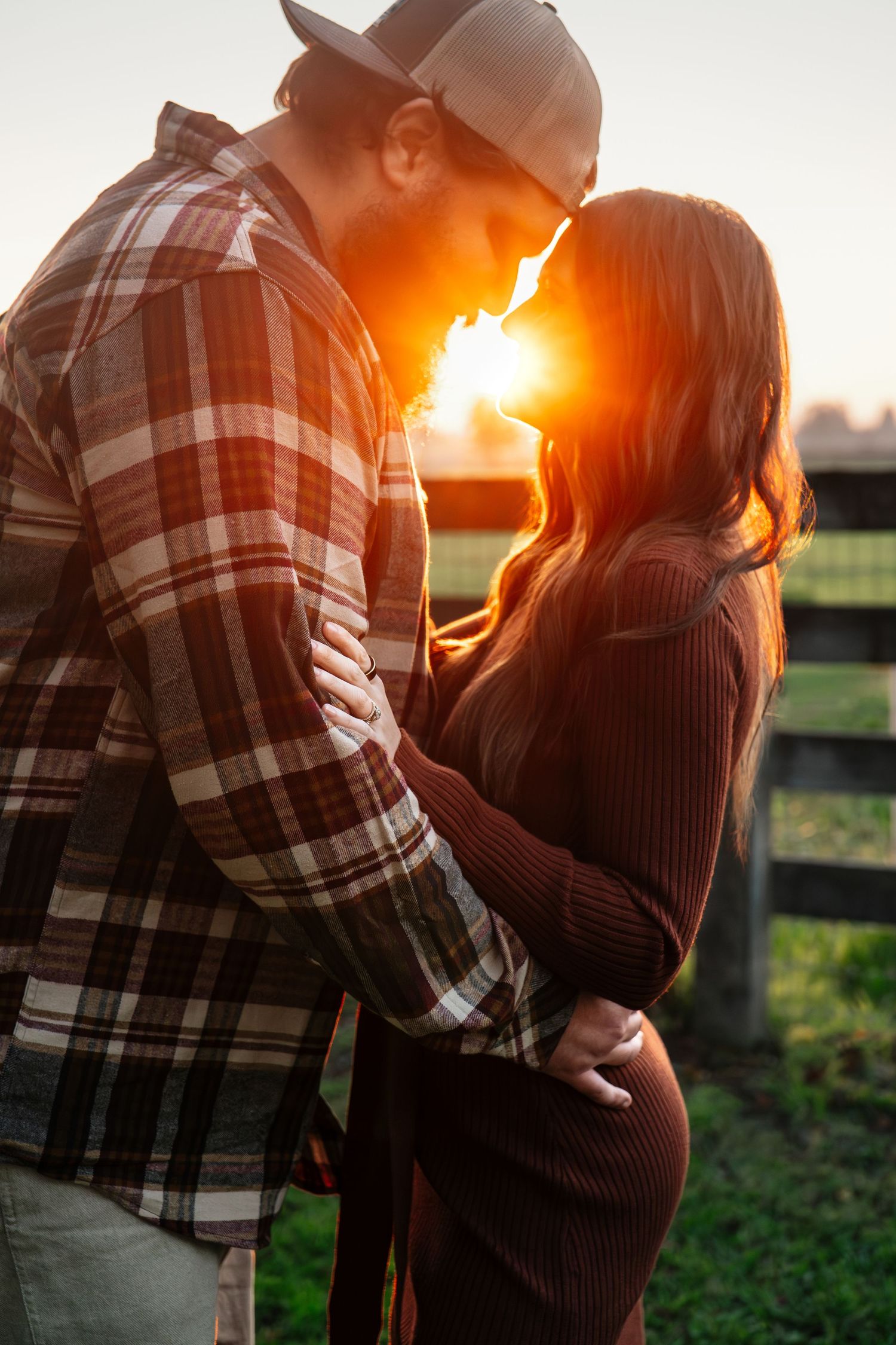 Couple embracing during golden sunset in a rustic outdoor setting in Roseville, CA