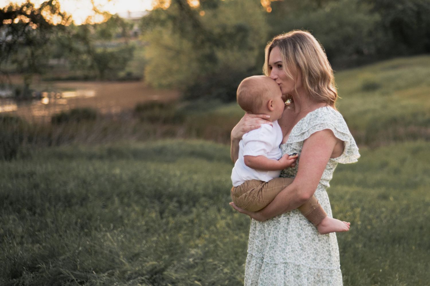Tender family moment captured during golden hour in natural outdoor setting. in Roseville, CA
