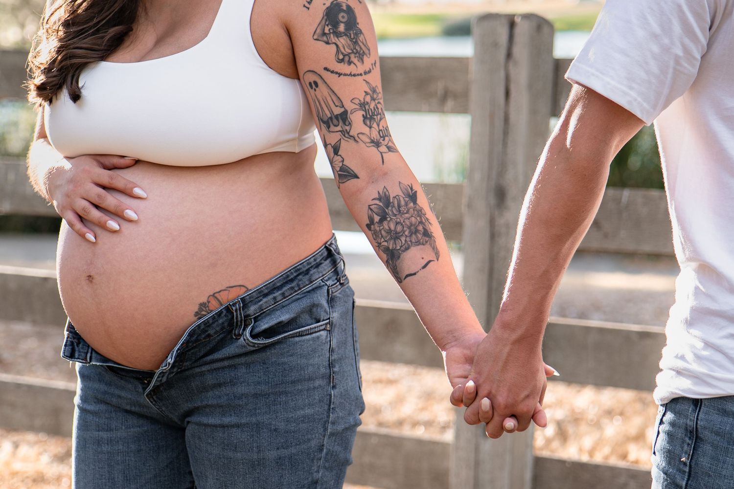 A series of cropped photos showing pregnant belly with tattoos and hands holding together in an outdoor setting.