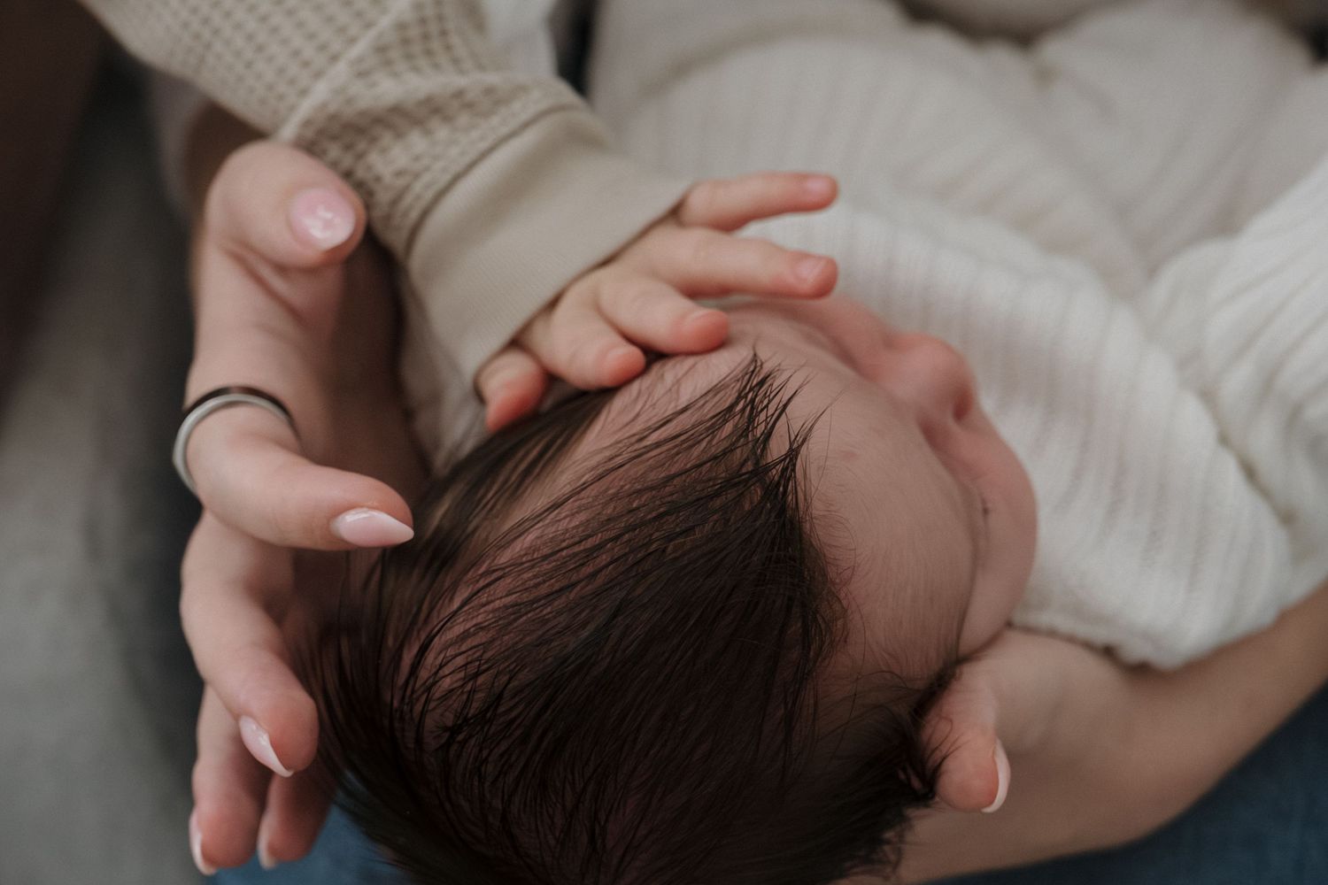 Close up view of a sleeping newborn baby wrapped in a white blanket in Roseville, CA