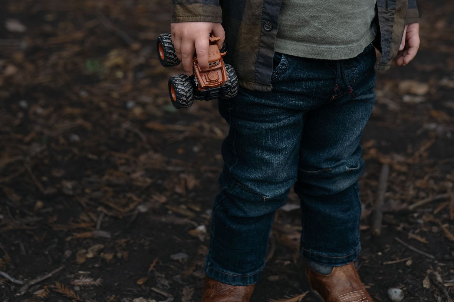 Closeup view of worn blue denim jeans showing distressed texture and fading details.