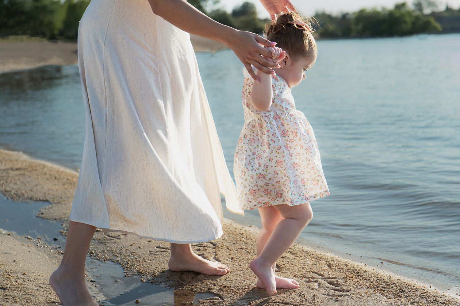 Family enjoying a tender moment by the waterfront in white summer outfits in Roseville, CA
