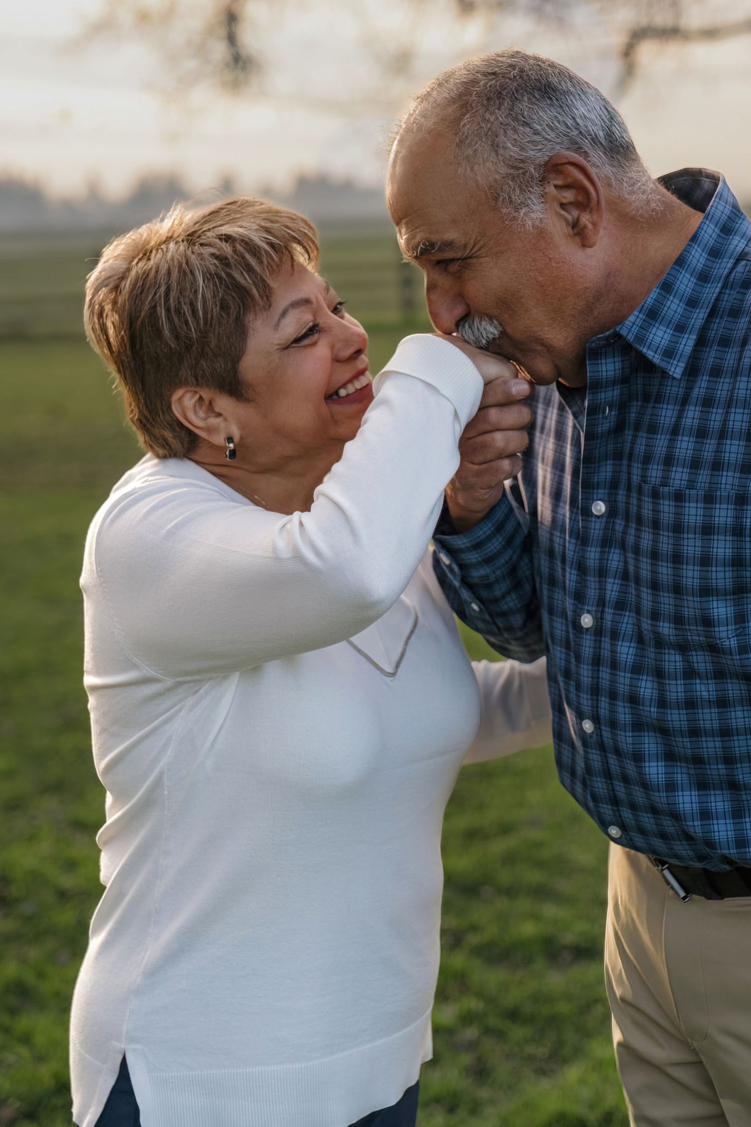 Elderly couple sharing a joyful and playful moment together outdoors in a sweet candid sequence.