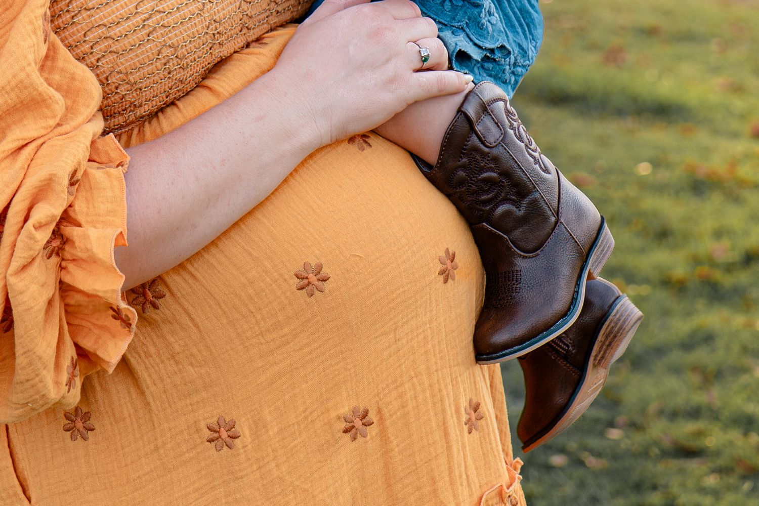 Close-up details of yellow dress and denim clothing in outdoor setting.
