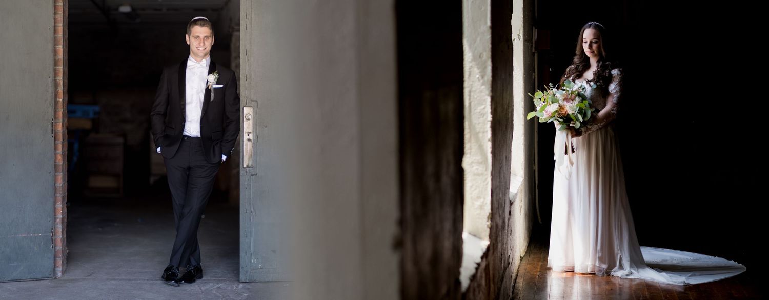 A couple shares an intimate moment during their wedding ceremony in a rustic venue with warm lighting.
