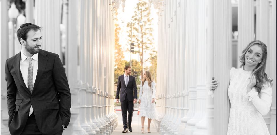 Engaged couple posing near elegant pillars during a photo shoot, capturing a romantic moment together.