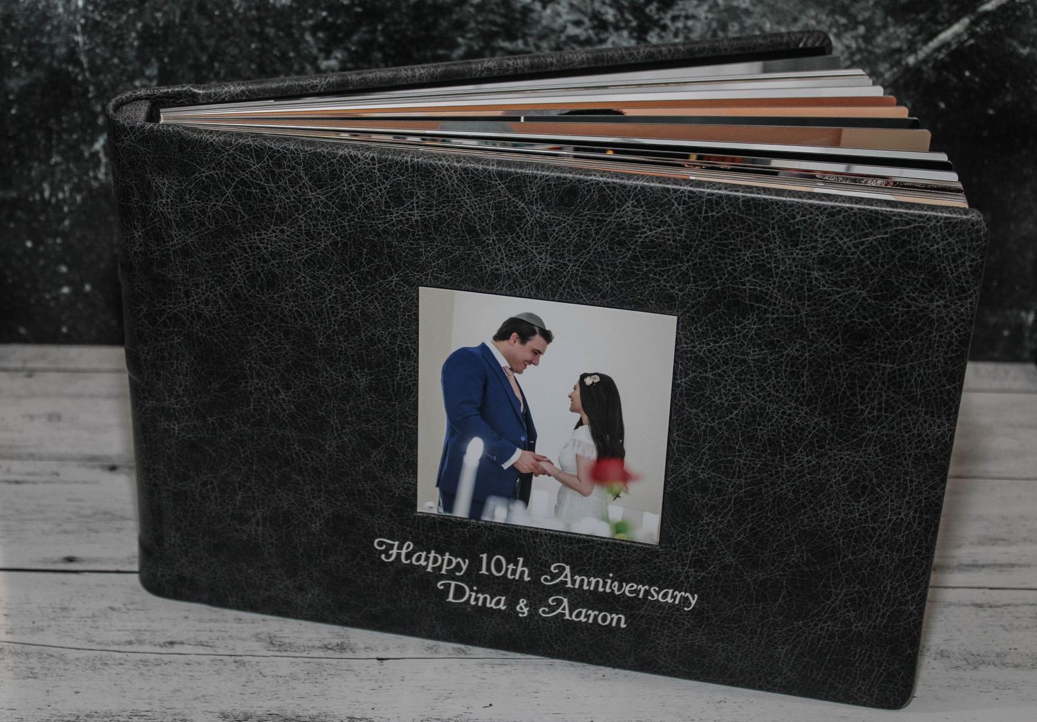 Anniversary photo album in gray distressed leather with elegant cameo window design