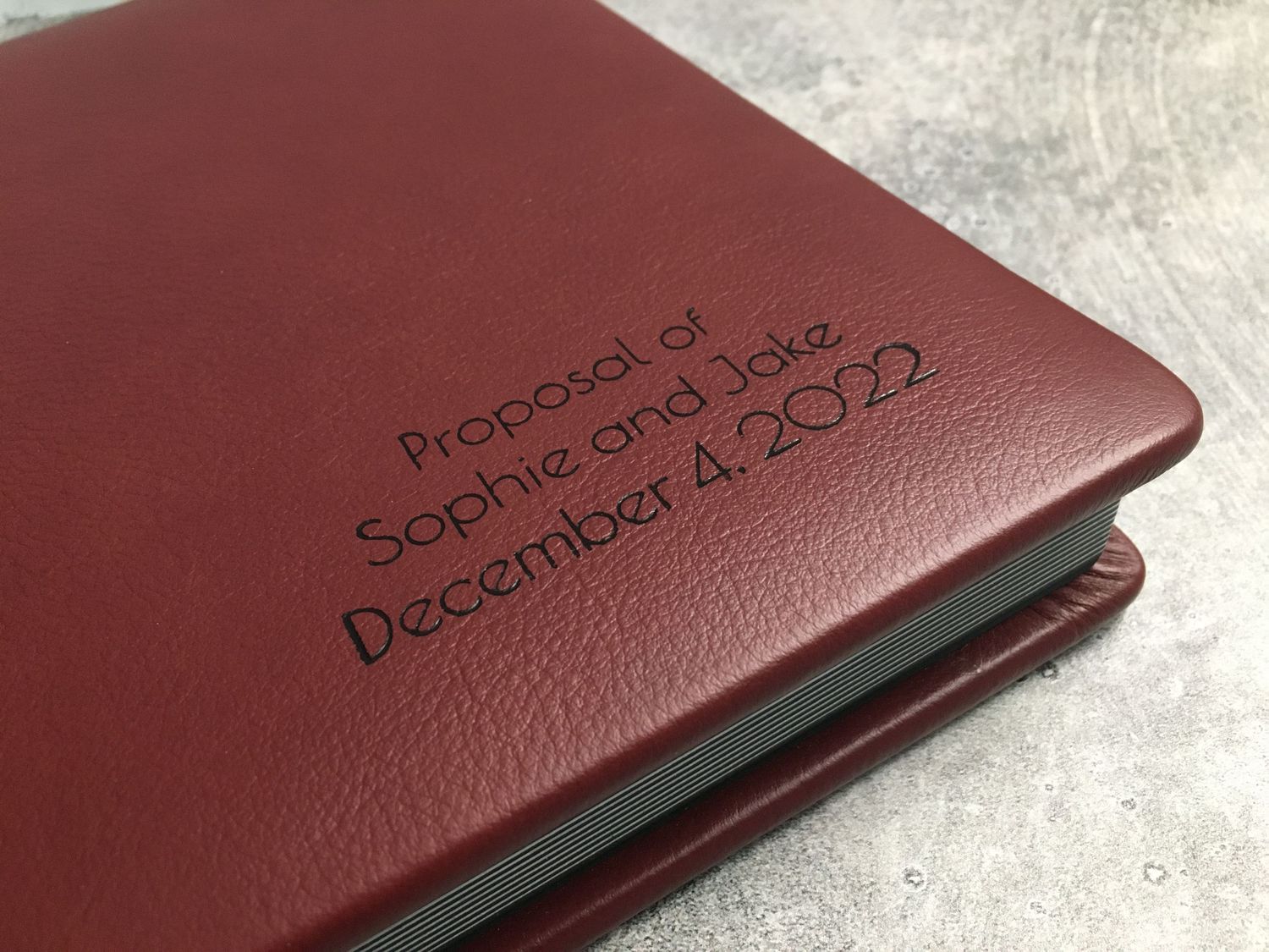 Burgundy proposal photo album displayed elegantly, highlighting rich color and timeless design.