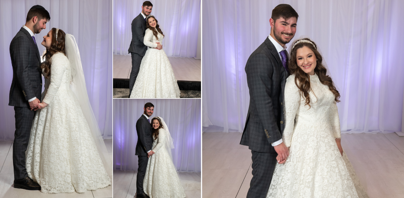 A wedding couple poses together in a white draped reception hall.