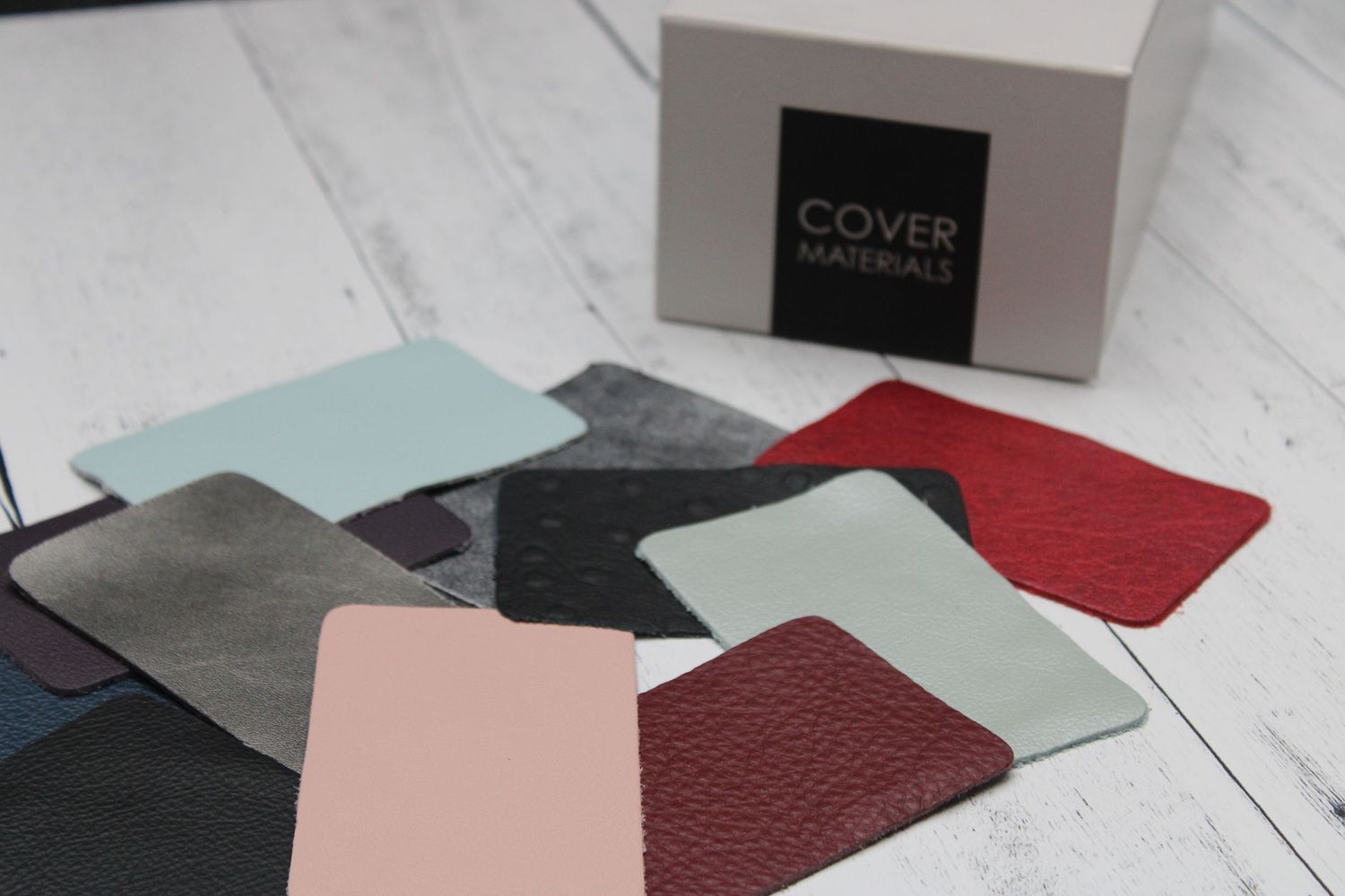 Color swatch display showing a wide variety of materials and vibrant shades for custom photo albums