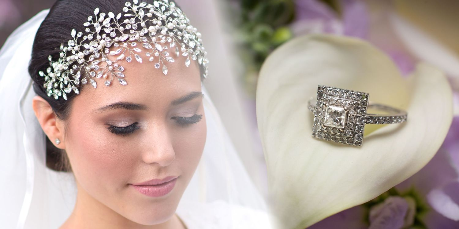 A delicate crystal bridal headpiece and princess cut diamond engagement ring on a white heart-shaped surface.