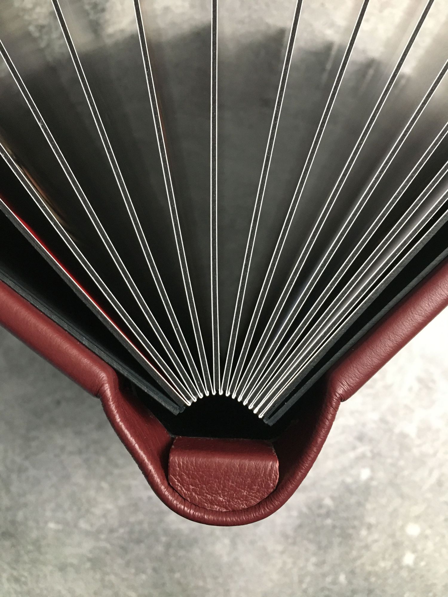 Close-up sequence showing the expansion of a burgundy leather photo album showing thick album pages