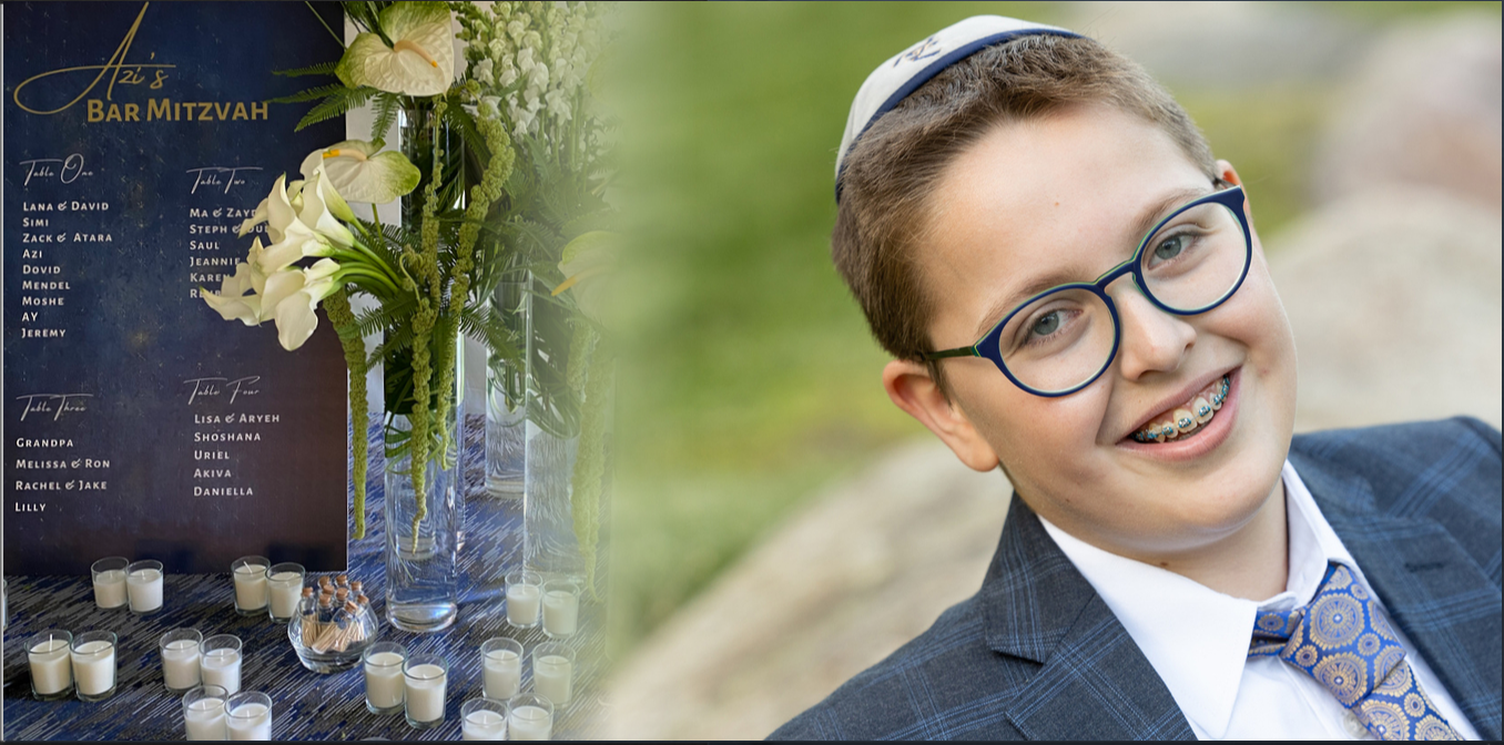 A bar mitzvah boy in glasses smiles warmly while sitting outdoors with blurred foliage in the background.