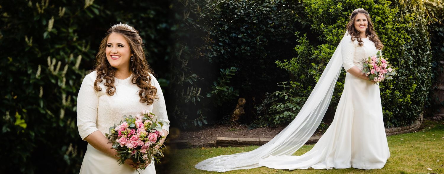 A bride in a white wedding dress poses outdoors in a garden setting with a pink and white floral bouquet.