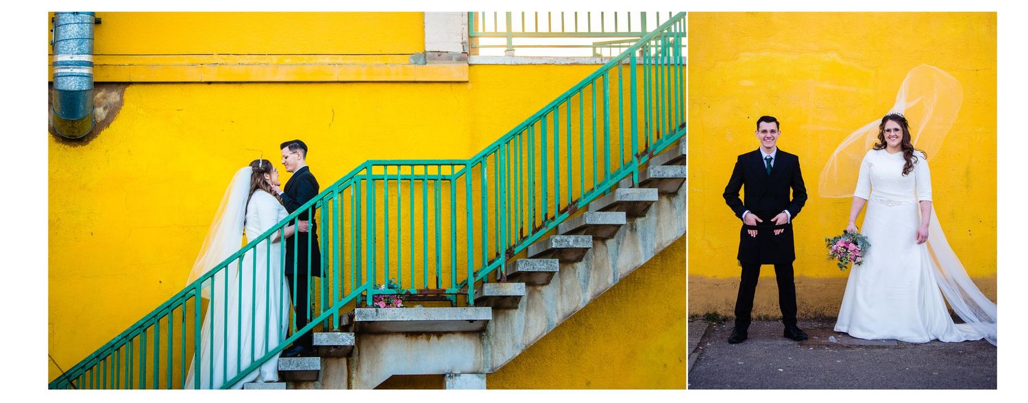 A couple poses on bright yellow and green staircase for wedding photos, creating a vibrant architectural backdrop.