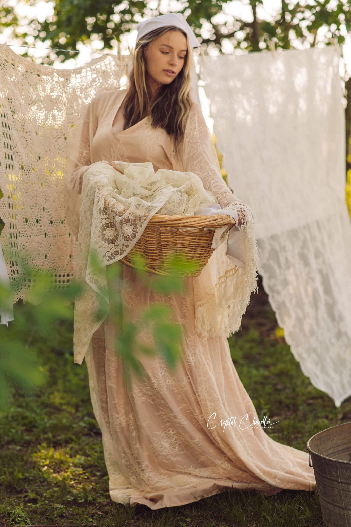 Photograhy, photographer, Mobile, AL Vintage-inspired laundry scene with woman in white dress carrying wicker basket outdoors.