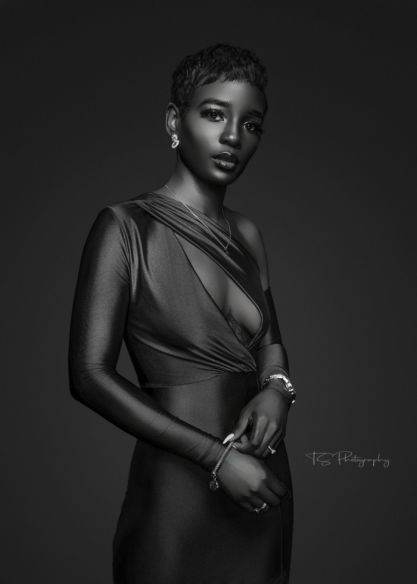 Dramatic black and white portrait in elegant draped evening wear with jewelry.