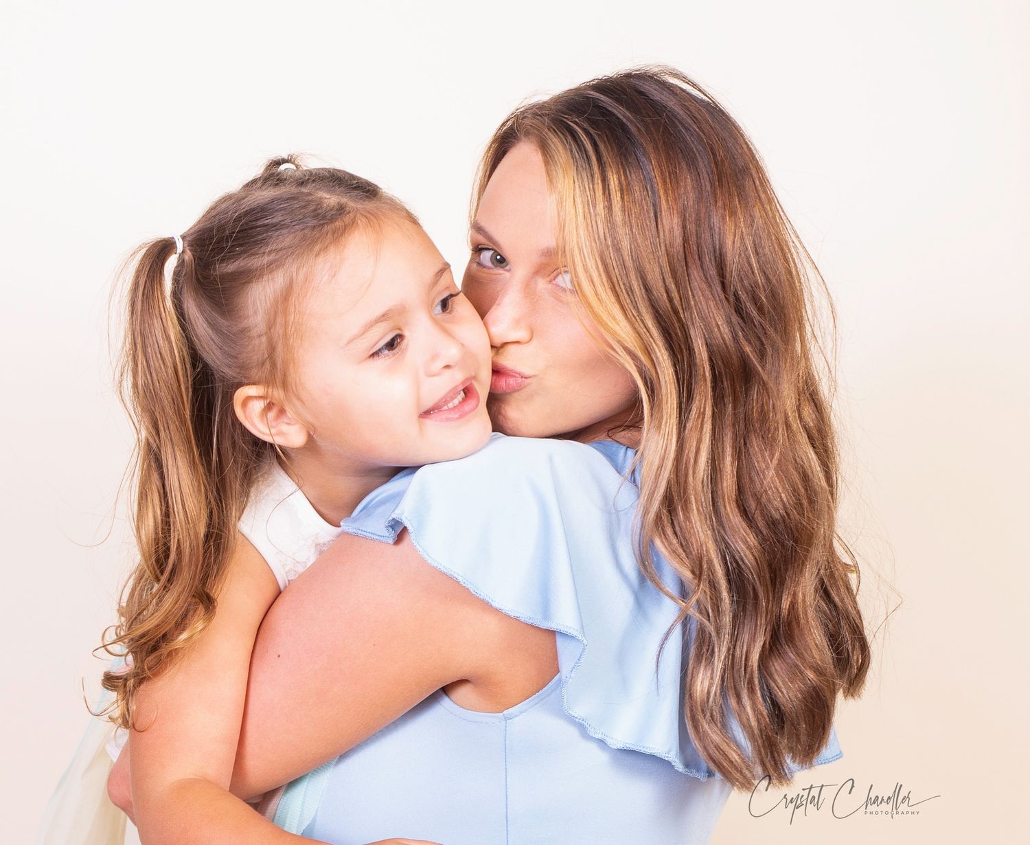 Photograhy, photographer, Mobile, AL  Tender moment captured in studio with soft lighting and blue clothing.