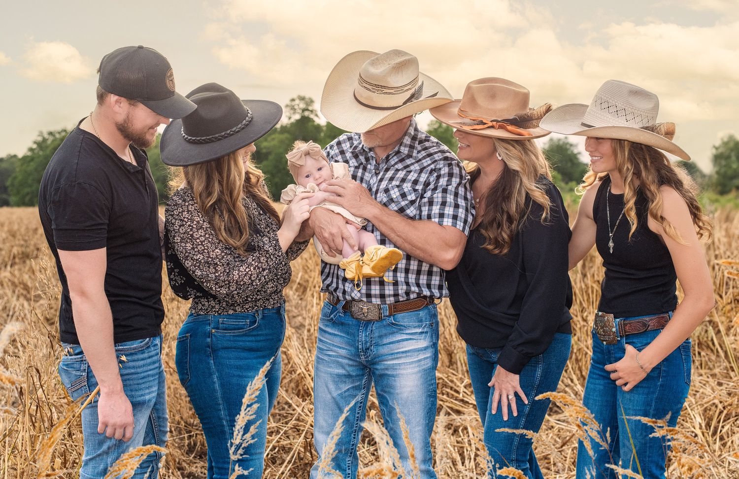 Photograhy, photographer, Mobile, AL  A family group wearing western attire and cowboy hats gathered in a golden wheat field at sunset.