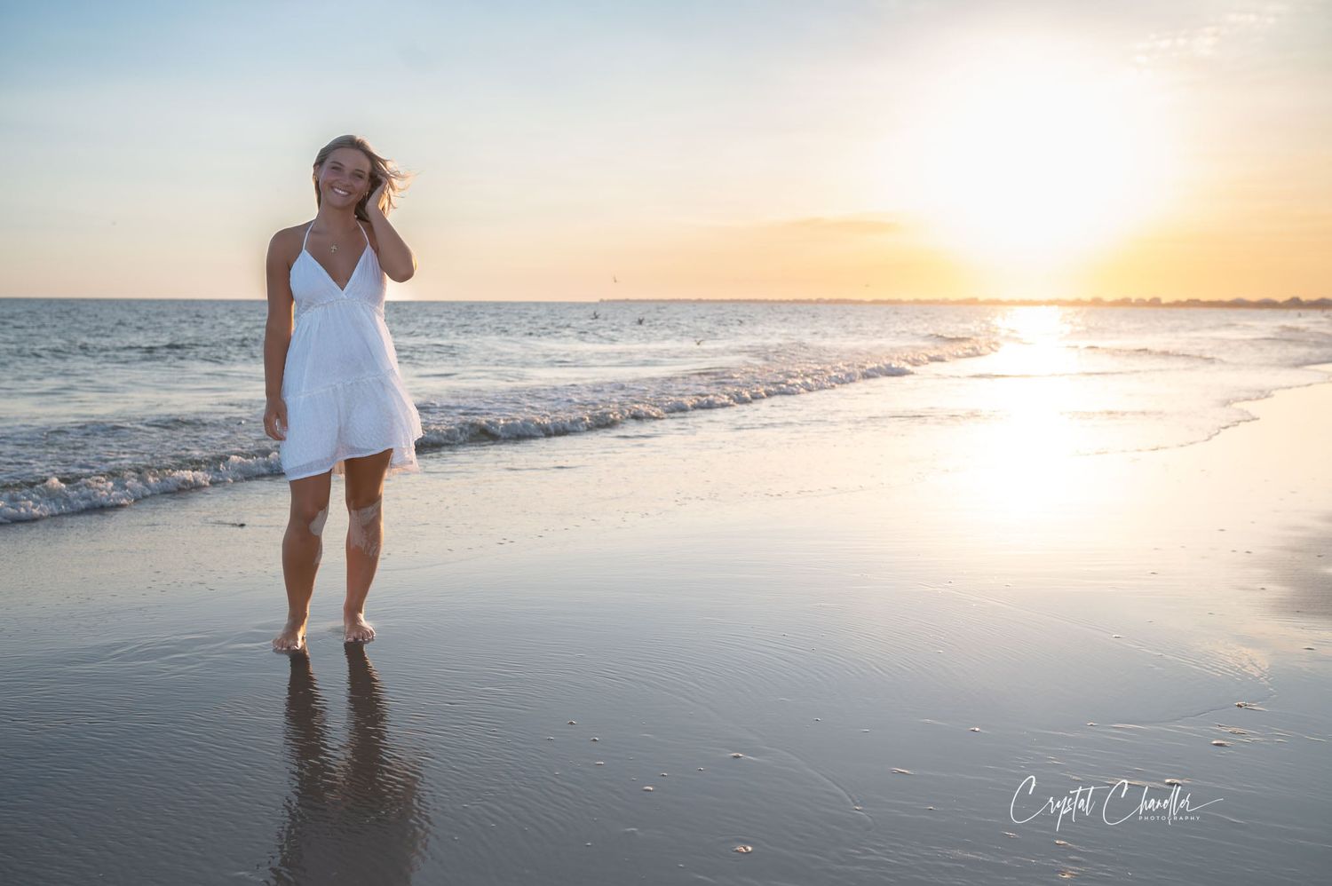 Photograhy, photographer, Mobile, AL  Serene beach scene with white dress silhouette against setting sun and ocean waves.