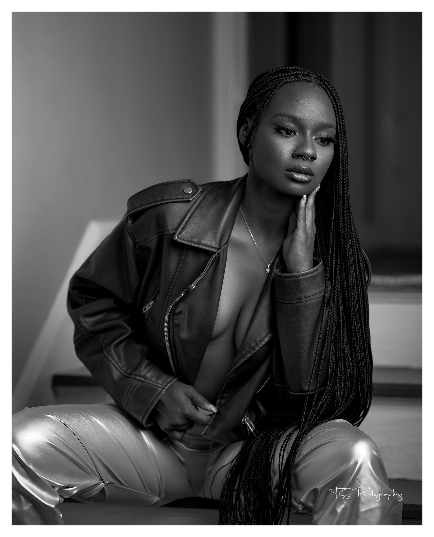 Photograhy, photographer, Mobile, Artistic black and white portrait featuring leather jacket and long braided hairstyle in moody lighting.