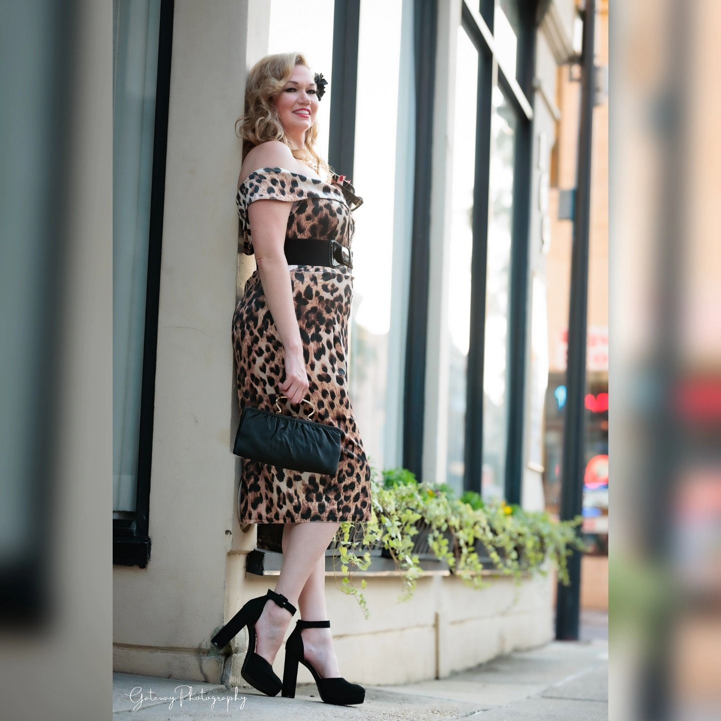 Street fashion portrait in leopard print dress and black heels.