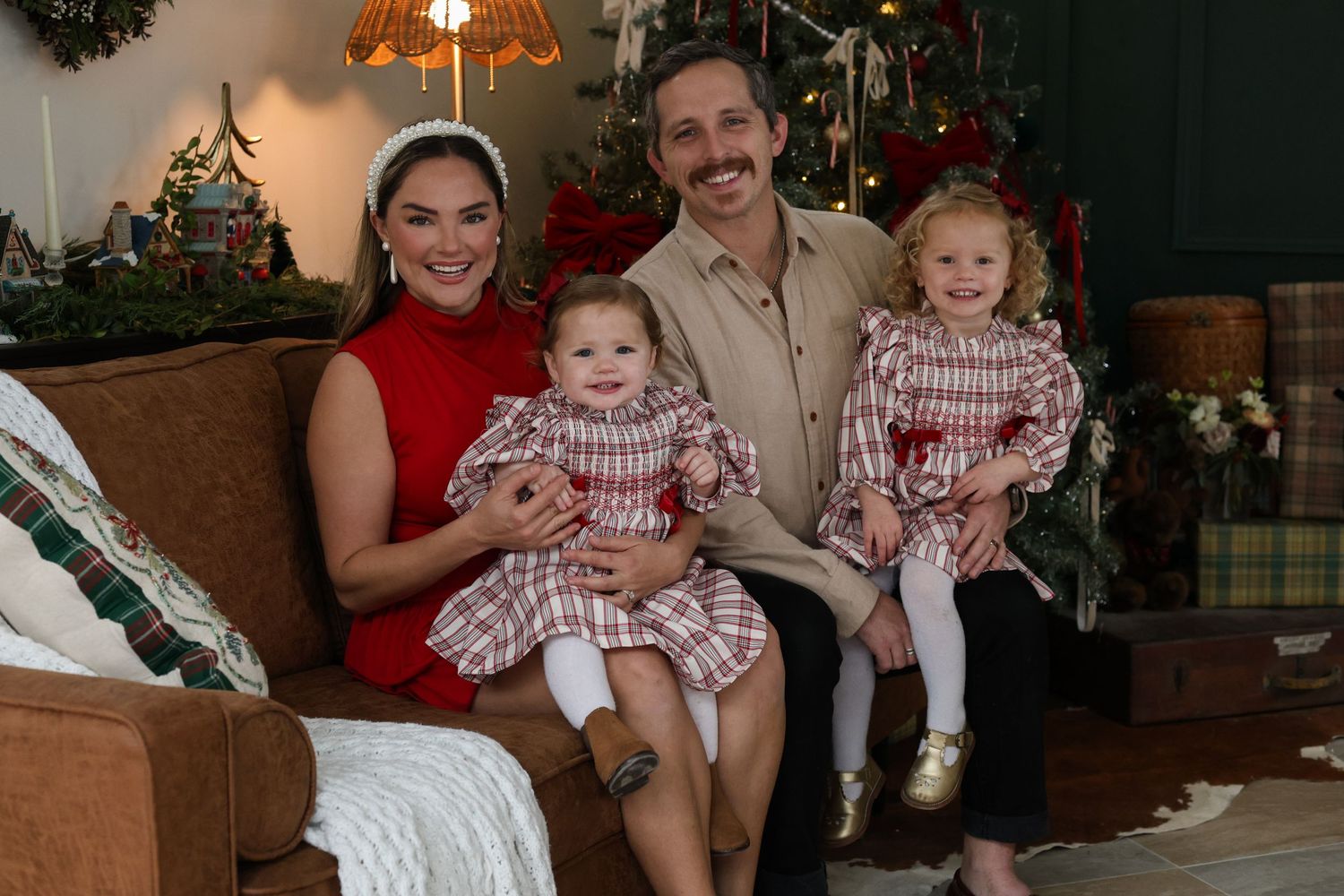 A festive family Christmas photo collage with matching red and white outfits in front of decorated trees and holiday decor.