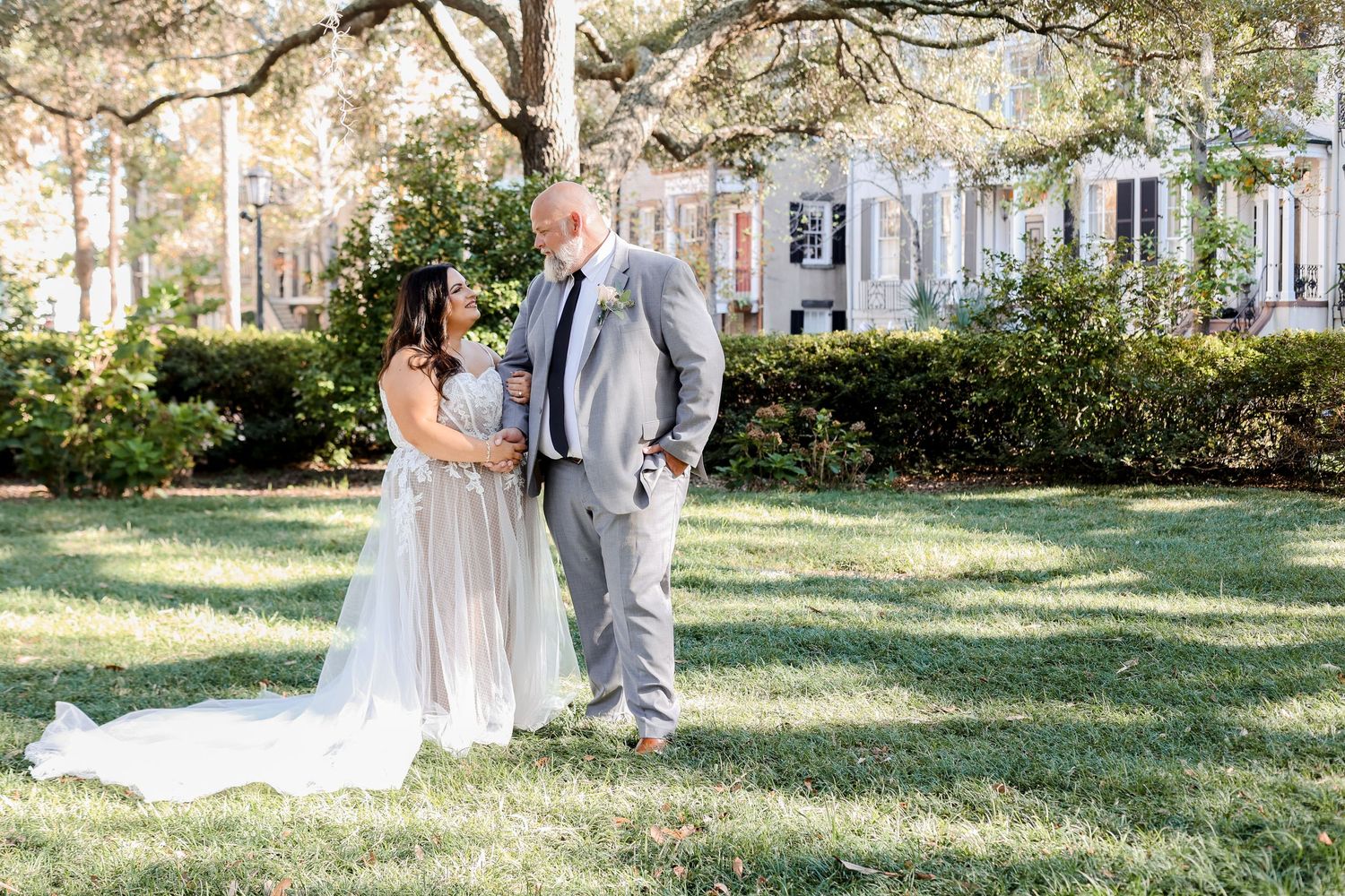 Elegant outdoor wedding portraits with couples in gray and blush attire under shaded trees.