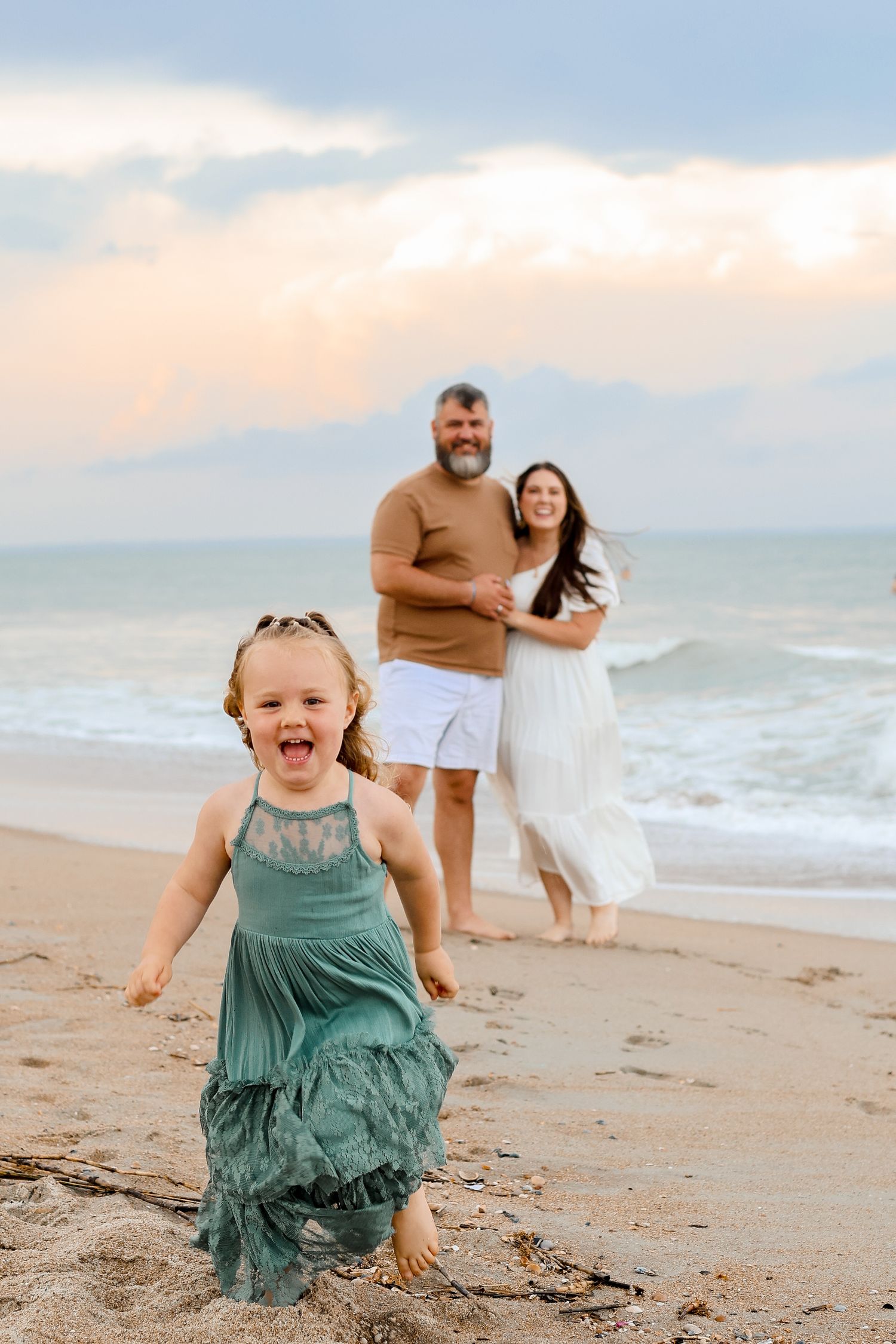 People enjoying a sunset beach photoshoot in casual attire.