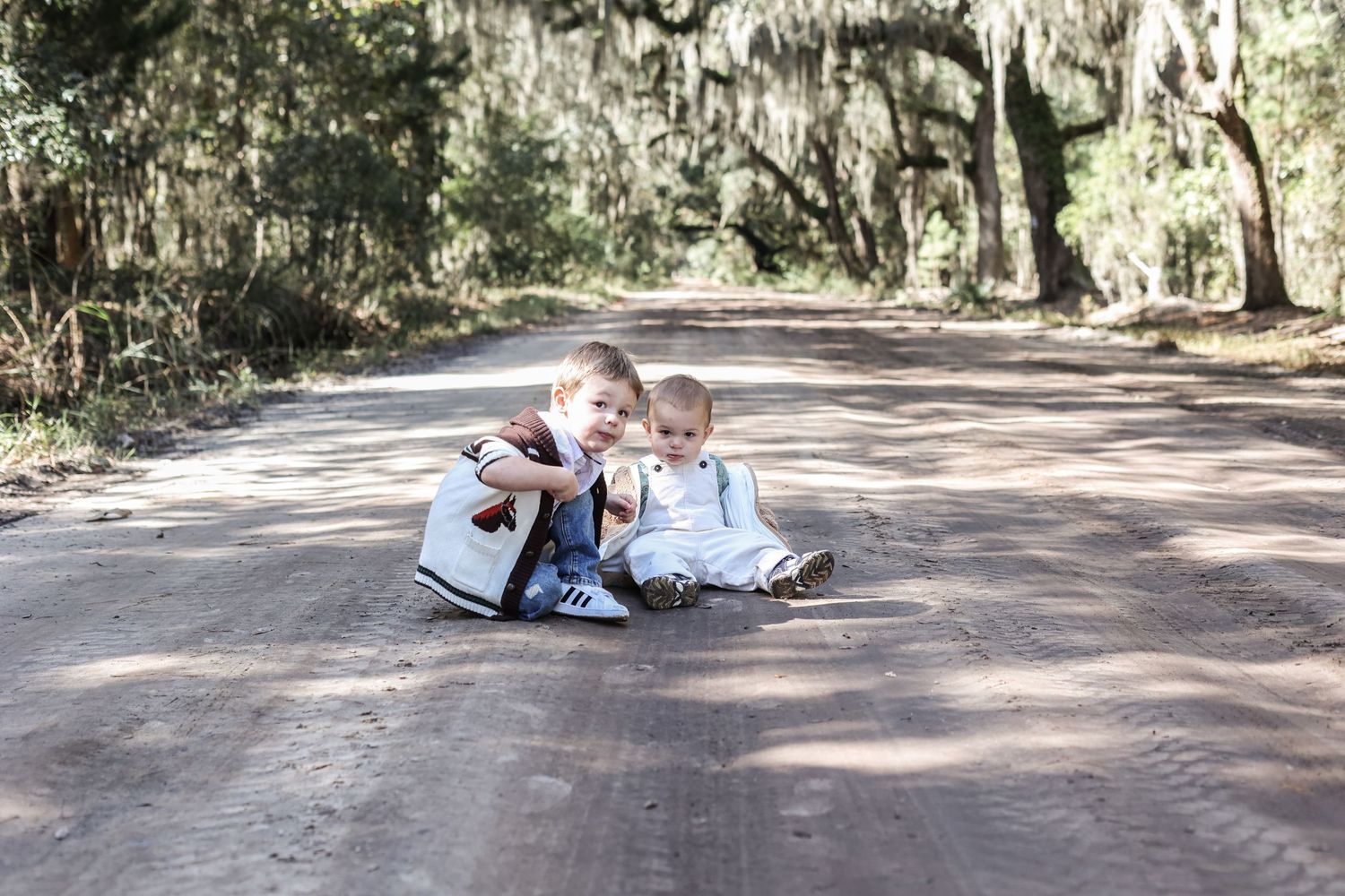 Casual family photoshoot on a tree-lined dirt path.