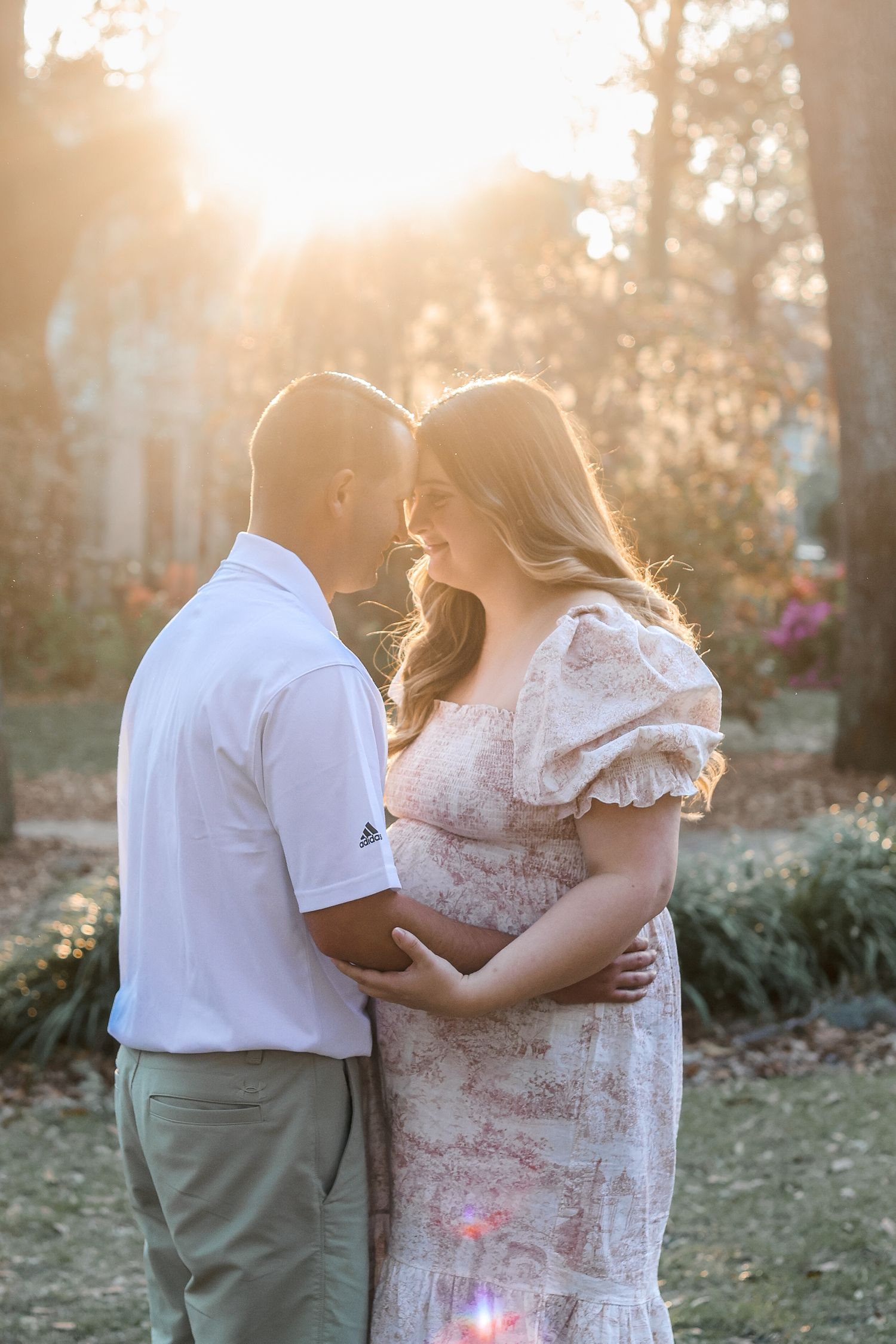 A romantic sunset portrait of an expecting couple sharing an intimate moment.
