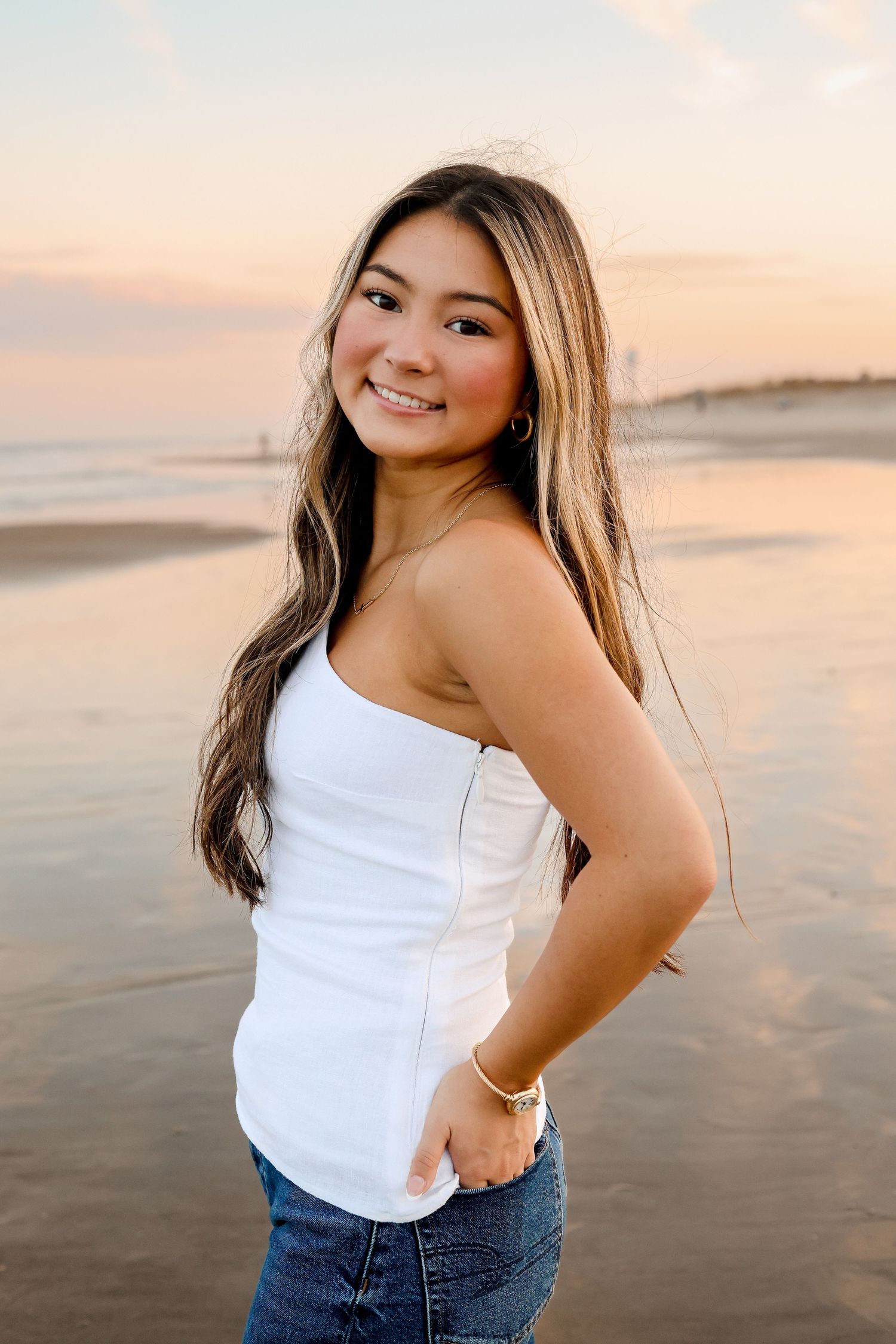 A series of sunset beach portraits showing someone in a white tank top and jeans posing against a golden sky.