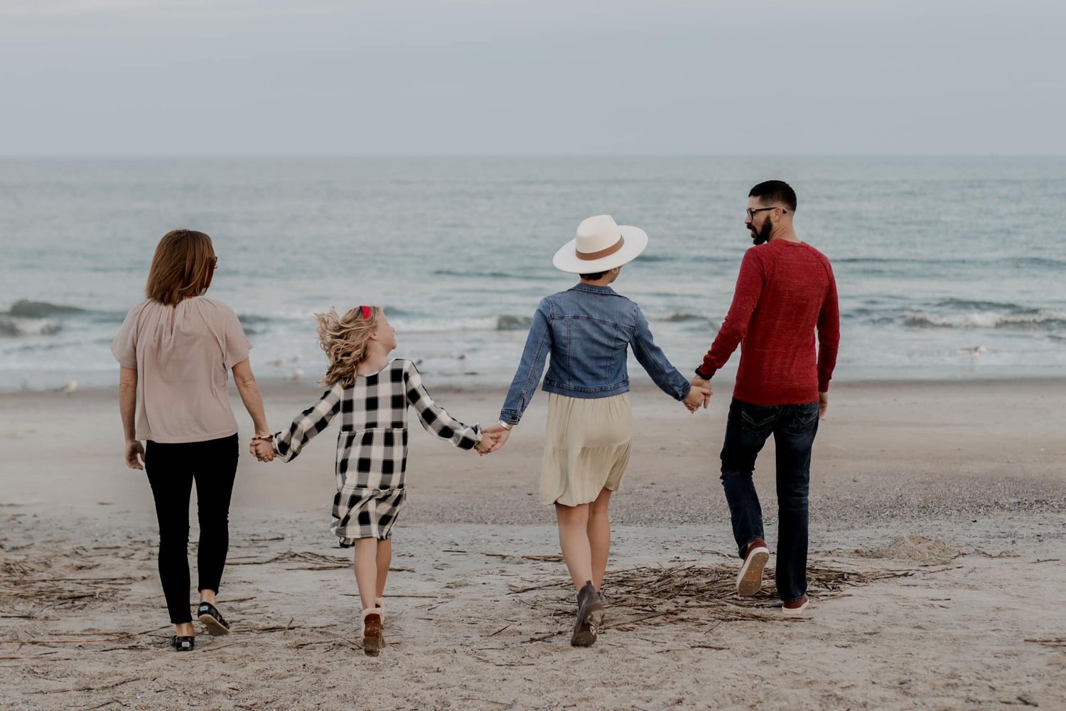 Group enjoys a peaceful walk along the shoreline at dusk.