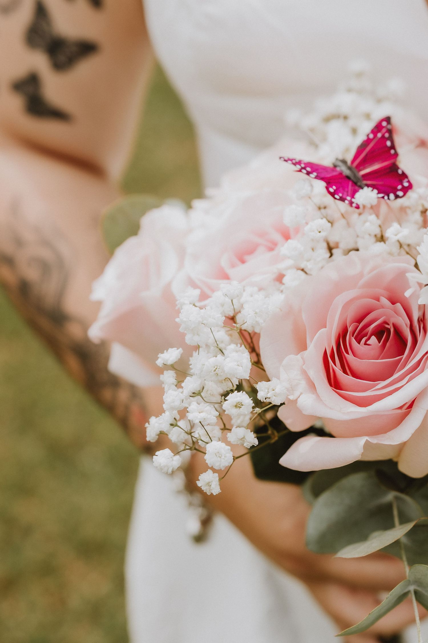 Delicate pink roses paired with small white baby's breath flowers create an elegant floral arrangement.