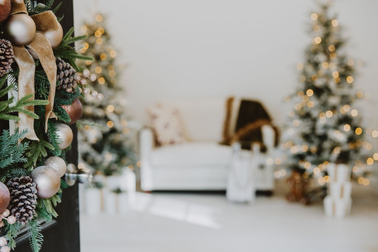 Holiday decorations and pine cones adorn a festive winter wedding setting with glowing lights and greenery.