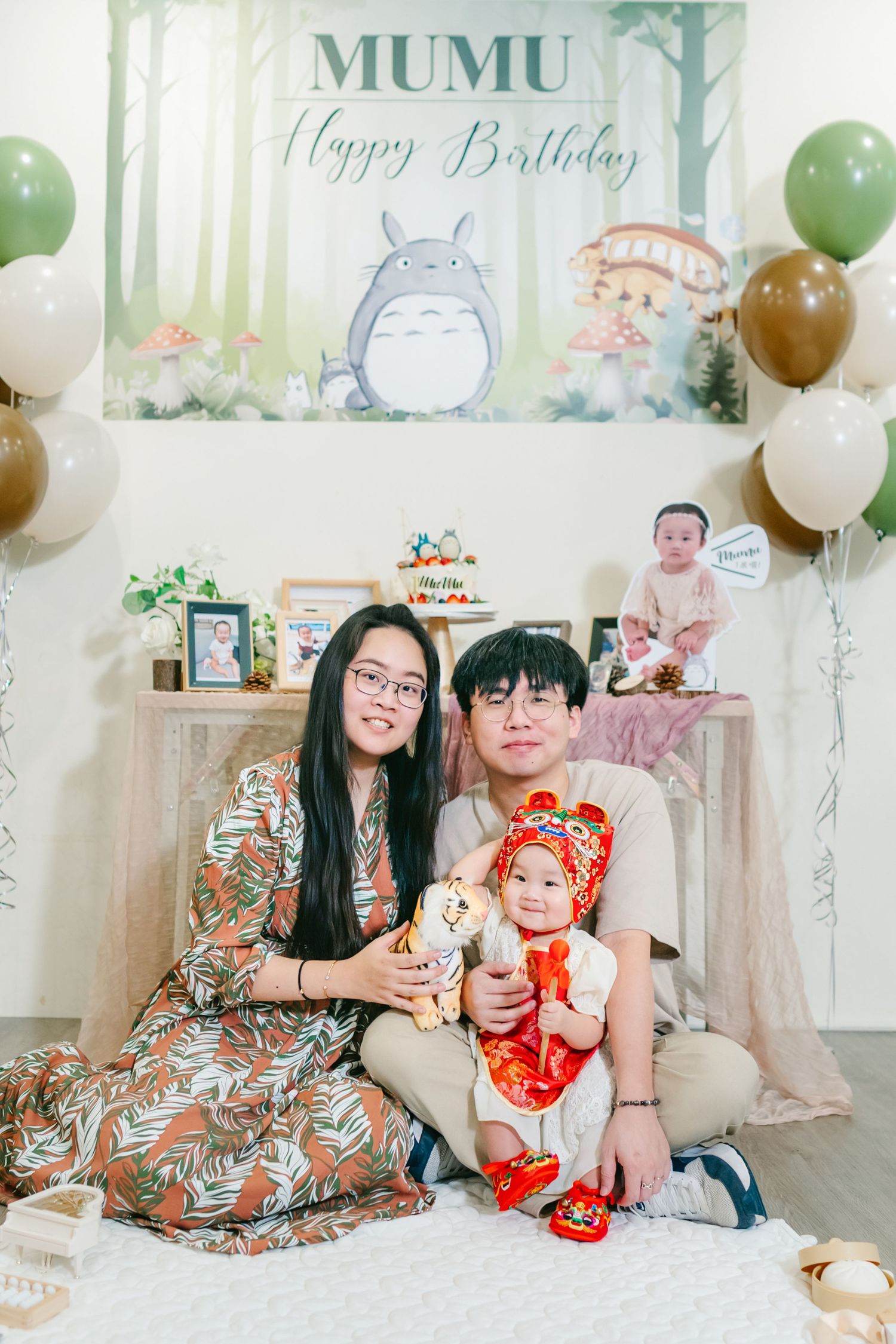 Birthday celebration with Totoro theme backdrop, festive balloons, and decorative party setup in soft pastel colors.