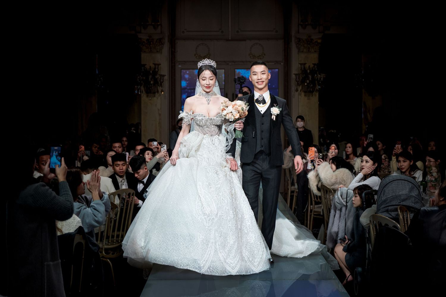 Bride in an elegant white ball gown twirls on the dance floor during a wedding reception celebration.