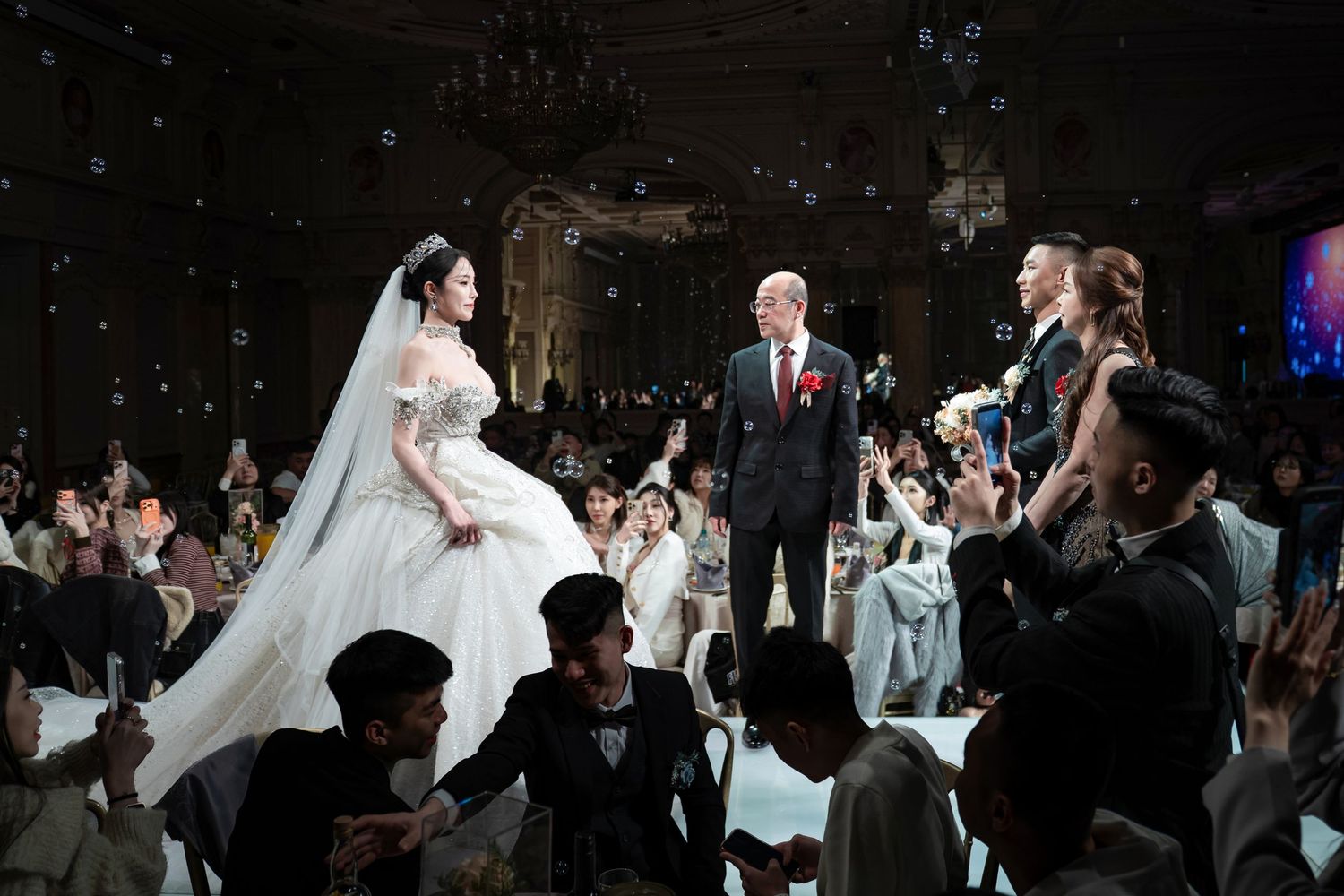 A series of wedding ceremony photos showing couples dancing and celebrating in formal attire at a dimly lit reception venue.