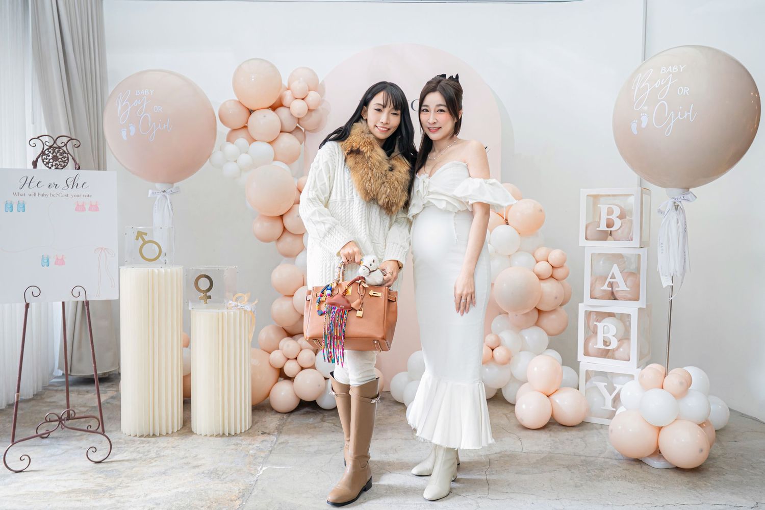 Elegant pink and white balloon decorations create a romantic atmosphere in a bridal studio setting.