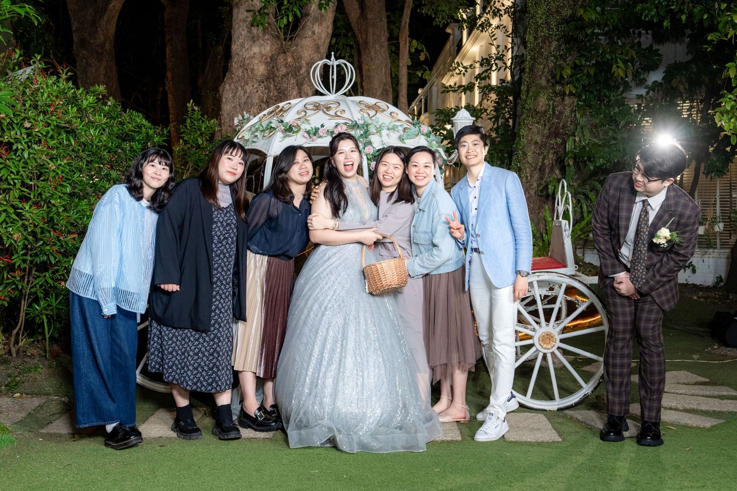 A series of outdoor wedding photos showing guests and celebrations in a garden setting with decorative wagon wheels.