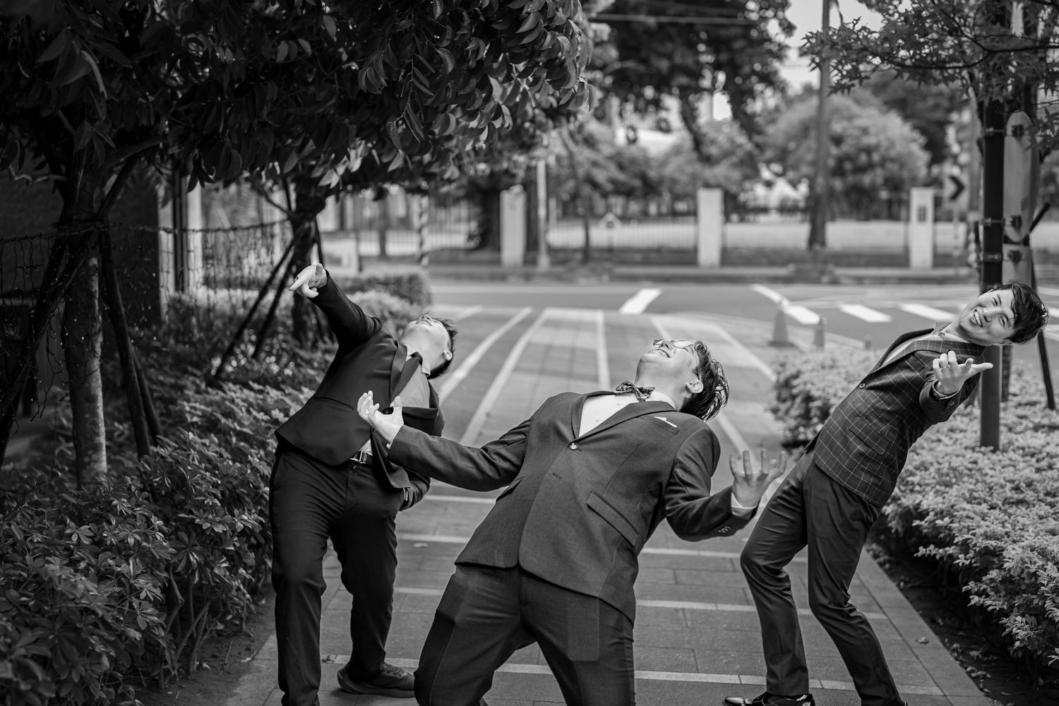 A series of black and white candid moments from a wedding ceremony showing guests and celebrations outdoors.