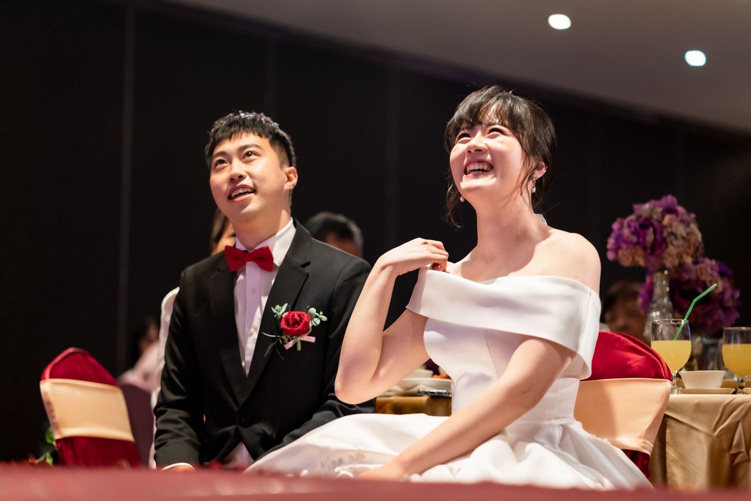 Newlyweds share a laugh during their wedding reception.